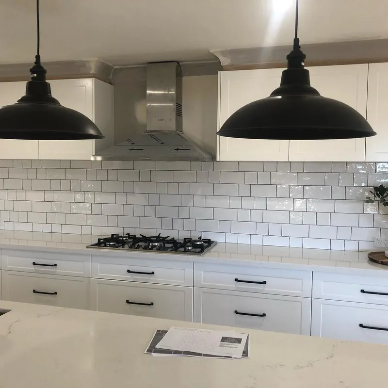 Hamptons-style kitchen with white subway tile splashback and marble benchtop