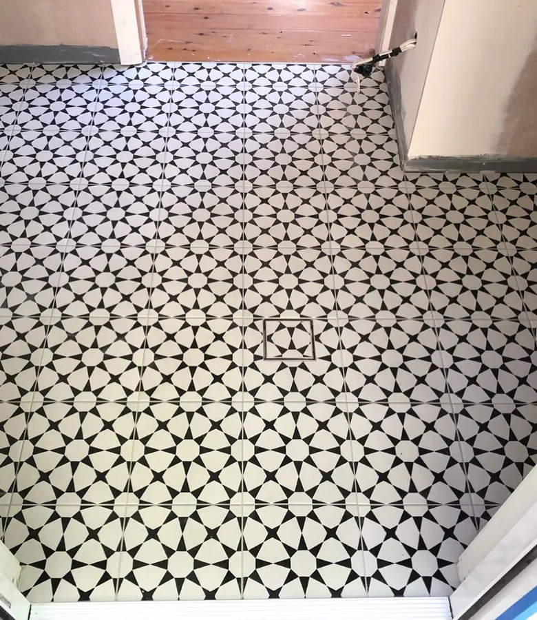 Black and white geometric encaustic pattern floor tiles, dramatic feature floor